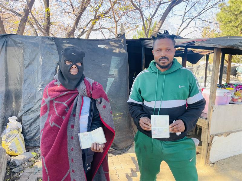 Ginger Park residents Tello Shadrake and Lililoro Pitsho show their passports amid reports of planned anti-migration marches. Photo: Ayanda Ntshingila