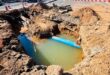 The newly discovered leak, located on a bend in the pipeline encased in concrete, has delayed the road reopening. Photo: Supplied