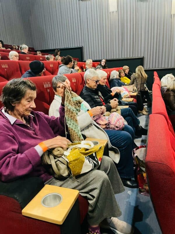 With needles clicking and yarn transforming into gifts of warmth, volunteers gathered for Community Hours' Knit at the Movies event, proving community is built not only through grand gestures, but through simple acts of generosity shared together.