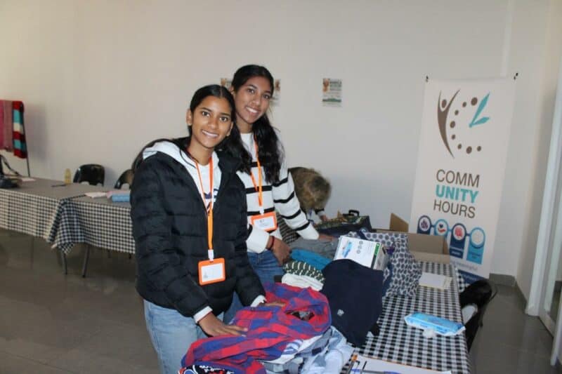 Volunteers Daiah munsamy and Sahuri munsamy folding donated clothes during the Mandela day pop-up donation centre at Cedar Square. Photo: Ayanda Ntshingila
