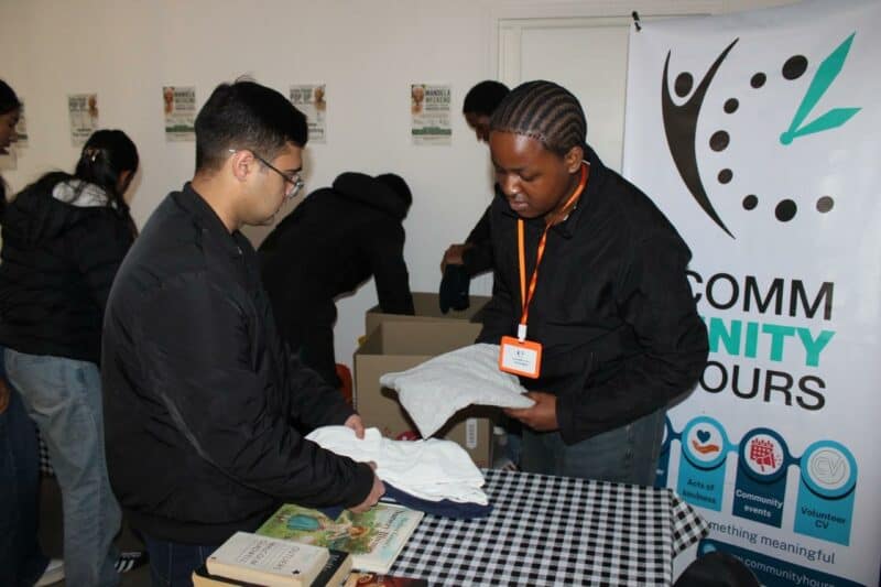 Volunteers Caleb moodley and Tshepang dladla helping during the Mandela day pop-up donation centre at Cedar Square. Photo Ayanda Ntshingila