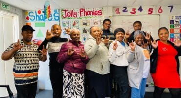 Sekunjalo sign language class makes a ‘I love you’ sign. Photo: Reitumetse Gugushe