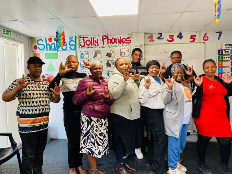 Sekunjalo sign language class makes a ‘I love you’ sign. Photo: Reitumetse Gugushe