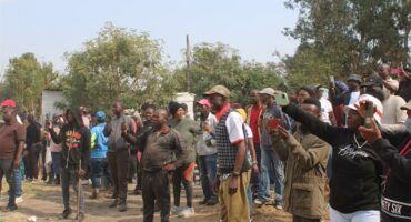 Community members with their phones out, capturing the moment when the church was being demolished on July 23, 2026. Photo: Reitumetse Gugushe