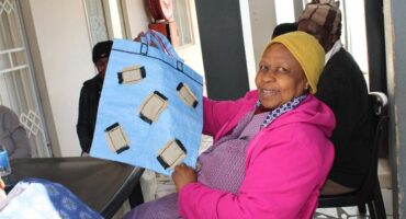 Rachel Wanyane, a member of the Tshwarafa Oldie Club, showcases her work, which she did during the club's daily meeting on July 17, 2026. Photo: Ayanda Ntshingila