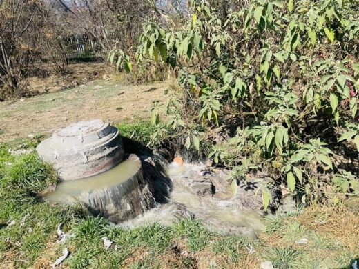 An overflowing manhole discharges wastewater into a channel leading to the Klein Jukskei River in Jukskei Park on July 30, 2026. Photo: Ayanda Ntshingil