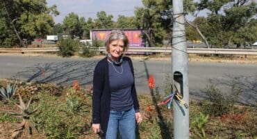 Resident Tracy Kensey stands by the exposed cables of a streetlight along Maxwell Drive in Sunninghill on June 25, 2026. Photo: Ayanda Ntshingila