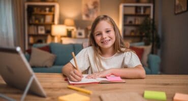a girl writing on a notebook