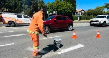 Kholofelo Maitisa paints fresh road markings outside Dainfern Square on October 22, 2026. Photo: Ditiro Masuku