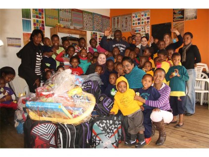 Seen with the donated goods are the good samaritans, the children as well as the employee of the home.