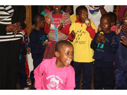 Seen with the donated goods are the good samaritans, the children as well as the employee of the home.