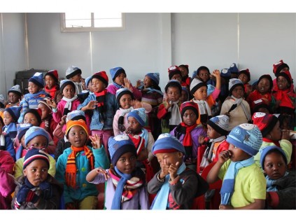 Children from Maria's Home and Mpumelelo Day Care Centre welcome guests with a song.
