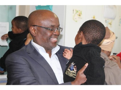 MEC tor the Gauteng Provincial Finance Department, Mandla Nkomfe, plays with the children at the Iguglethu Place of Safety Children's Home.
