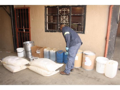 Acting on a tip-off, police raided a suspected drug house on Leon Ferreira Street, Reiger Park, and found a large amount of chemicals which are apparently being used to manufacture drugs. Seen examining the discovered chemicals is Sgt Mashudu Phathela, a spokesman for the Reiger Park SAPS.