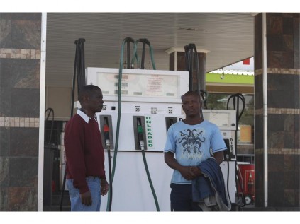Diesel tank nightmare survivor, Amosi Nomalusa, and cousin of the deceased, Edward Kathumba at Central Service Station, a week after the fatal death of Benson Maruo.