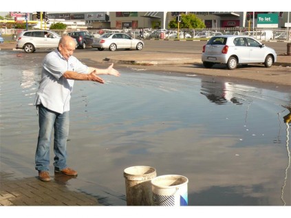 George Tinny, a manager at United Furniture Outlets, is frustrated by water that floods the area in front of his busienss, as a result of an apparent non-functioning stormwater drain.