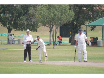 Tumelo Simelane delivers while Jan van Rensburg (right) looks on.
