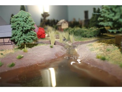 Many of the pieces on the train layout can be bought at a hobby shop, and some can be made such as this water, which was made with glue.
