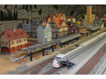 The train moves smoothly through the different German cities, making a pitstop at the train station.