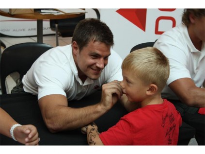Lions centre JW Jonker signing on a young fan's face.