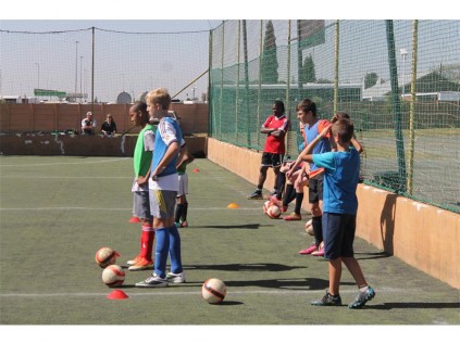 Players, alongside Clement Mazibuko (red T-shirt), look on during a demonstration.