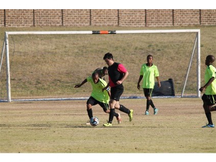 CBC striker David de Oliveira (black) challenges for the ball in their ELFA match against LK Stars, Stars won 2-0.
