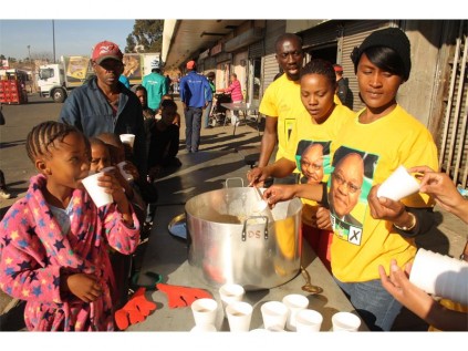 To mark Mandela Day, the Reiger Park ANCYL reached out to hundreds of hungry people, including children of Reiger Park. Seen are some of the residents who benefited as well as members of the ANCYL. They are (from left) Andile Ndepa (chairperson), Raylene Foster (deputy chairperson) and Sharline Hector.