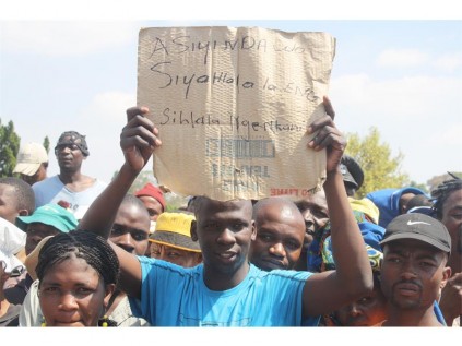 Seen carrying a placard bearing the words "asiyi ndawo, siyahlala la Angelo. Sihlala ngenkani" (We are going nowhere. We are permanently staying here in Angelo by force) is one of the protestors, who marched to the Boksburg Civic Centre.