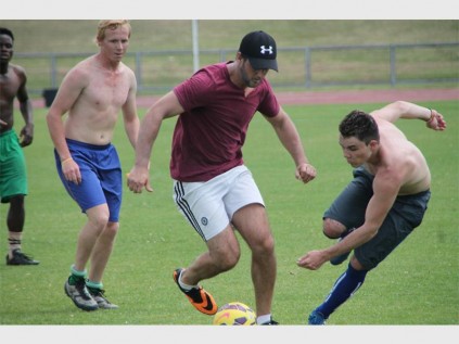Darren Maia shields the ball from Shane Olyott (right), while Christo Dewannaar (left) looks on.