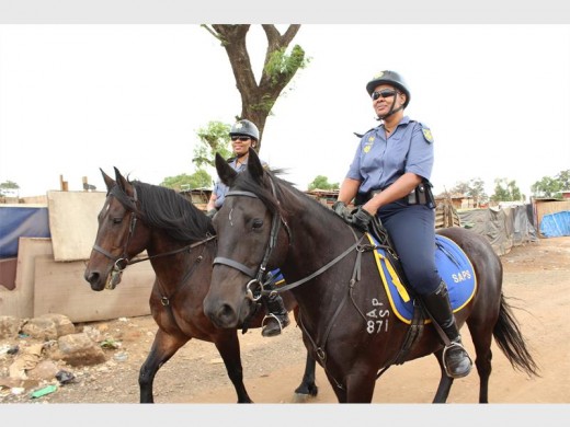 Members of the East Rand Mounted Unit were among the scores of police officers who took part in the anti-crime operation on Thursday. Seen patrolling the area on horseback are Sgt Puseletso Solo and Sgt Thuli Ngobese.
