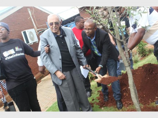 A tree was planted in honour of Dawn Park Primary School taking a stand against racism. Seen here are (from left) Ahmed Kathrada and Sello Hatang (CEO of Nelson Mandela Foundation).