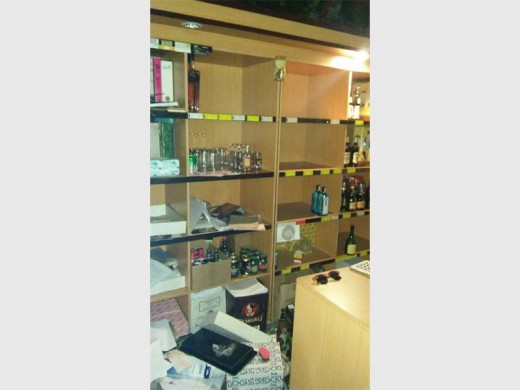 Empty shelf space where expensive liquor was stolen.