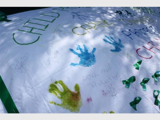 Each person who signed the banner received a green ribbon which symbolises their support and care towards children who have been abused and survived, as well as those who did not survive.