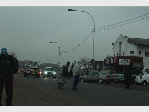 FILE PHOTO: People struggle to cross Main Reef Road in Angelo informal settlement.