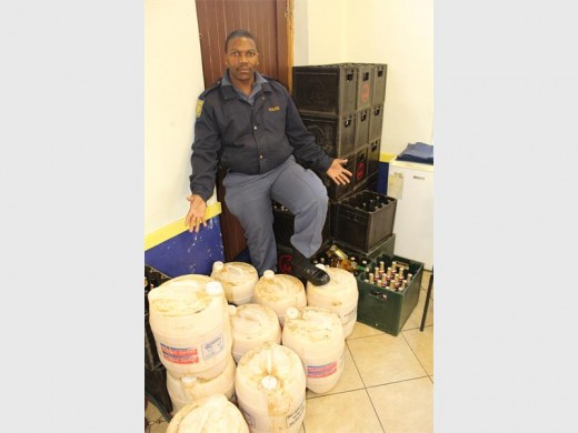 Two people were arrested in Jerusalem and had their illegal shebeens shut down in a joint police operation in Boksburg. Seen with the confiscated liquor is Boksburg SAPS’ liquor officer Const Thokozani Ntshalintshali.