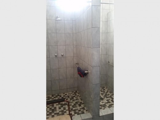 The men and women showers are right next to each other, without a shower door or curtain to close for privacy.