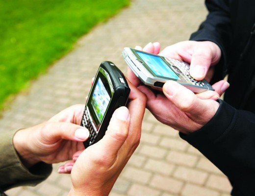 Hands of man and woman using pda