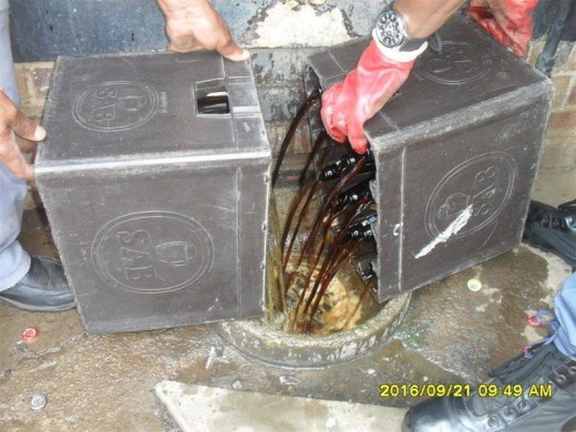 Seized alcohol worth thousands of Rand goes down the drain. Photos courtesy of the Reiger Park SAPS.