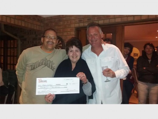 Laura Kirsten from Hospice East Rand (middle), accepting the cheque worth R70 000 from Theo Davids (left) and Mark Beneke (right)