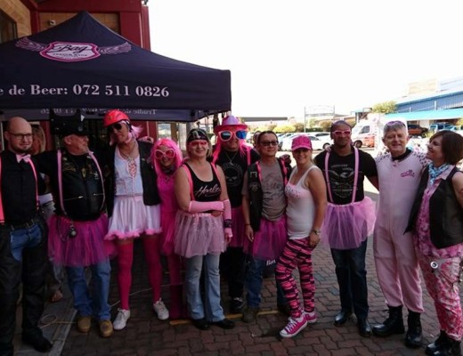 Everybody was dressed in pink in support of breast cancer. There were men and women in pink dresses, stockings, make-up and skirts.