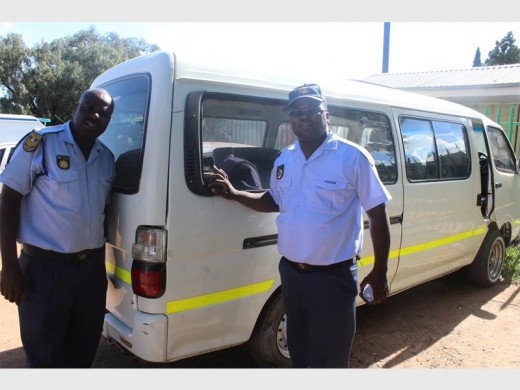 Sgt Mashudu Phathela and Const Jan Mokwana are seen with the now confiscated Kombi the suspects used to apparently obstruct the view of passers-by and the police officers.