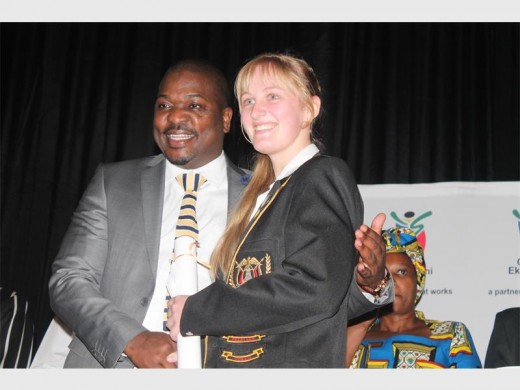 MMC Doctor Xhakaza congratulating Hoërskool Dr EG Jansen learner, Chris-Mari Halley (best performing learner overall).