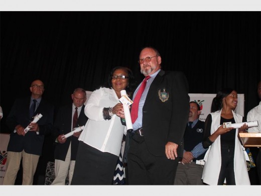 Boksburg High School principal Jan du Plessis  being awarded a certificate for coming in second position for best performing schools in the matric class of 2016.