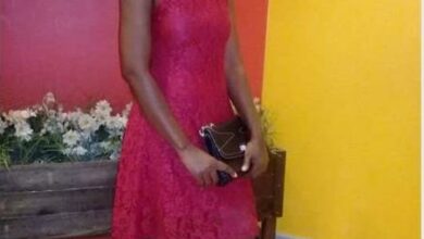 Woman in a red dress posing for a photo.