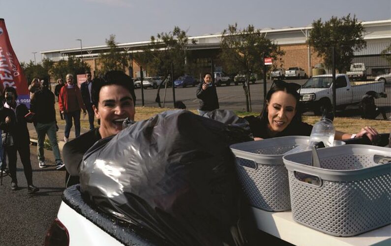 Hannon and Christene pushed a bakkie filled with non-perishable food, clothing, and toys.