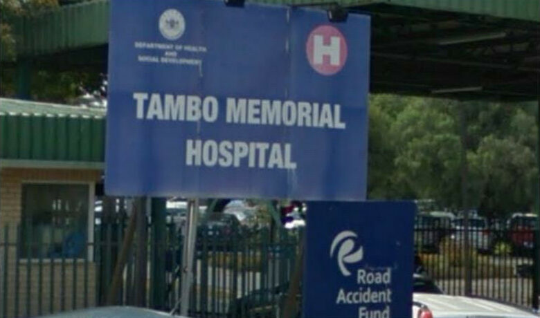 The signboard of Tambo Memorial Hospital displayed in bold white letters on a blue background.