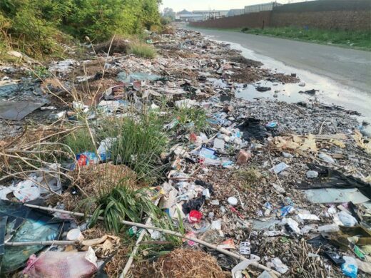 Heaps of mixed household and commercial waste waste on the roadside with other waste material