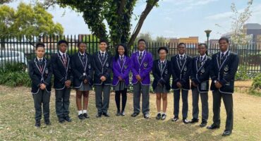 School learners, standing for a picture.