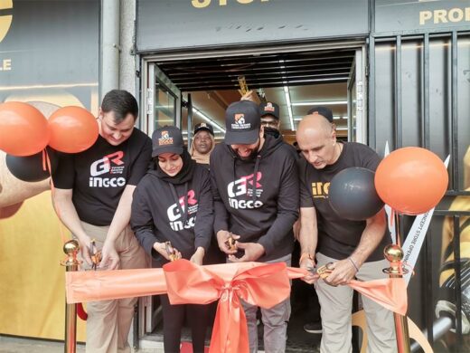 Four people, three mene and one woman, cutting a ribbon to mark the opening of a business in Witfield, boksburg