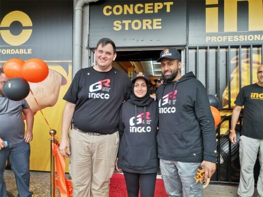 Two men and a woman posing for a group photo outside a newly opened store in Boksburg.